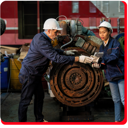 Two industrial restoration technicians inspecting and repairing heavy machinery at a Toronto facility, focused on equipment recovery and maintenance.